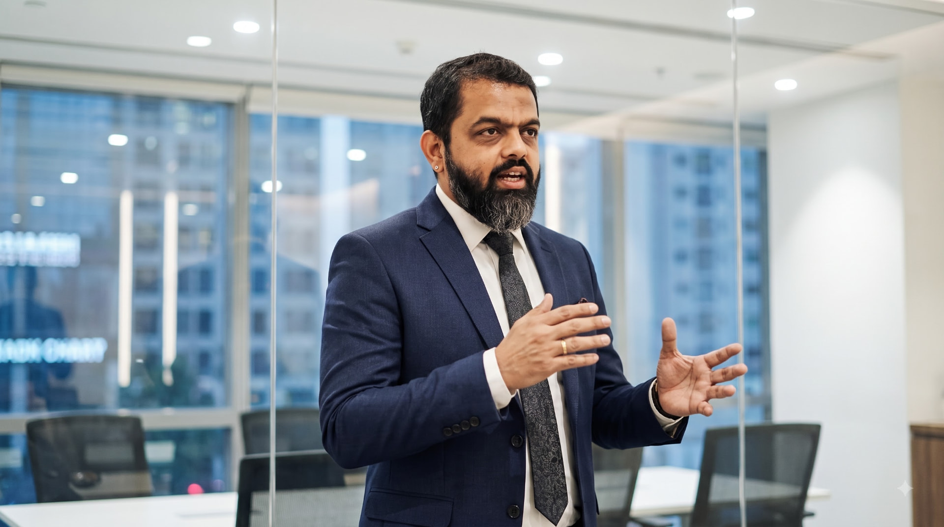 Chaitanya Bailey speaking to a leadership team in a conference room